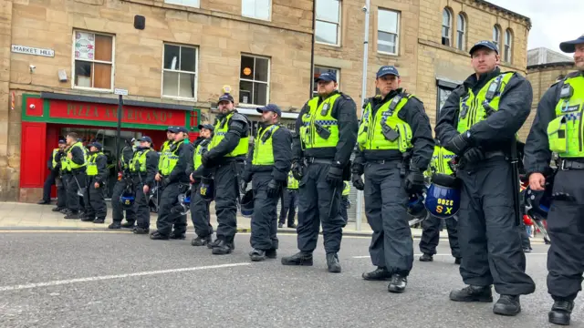 Police form a line in a street in Barnsley