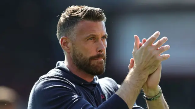 Rob Edwards, Manager of Luton Town, applauds the fans prior to the Premier League match between Luton Town and Fulham FC at Kenilworth Road on May 19, 2024 in Luton, England.