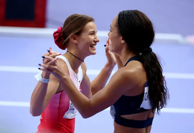 Adrianna Sulek-Schubert of Poland reacts after winning heat 1 with Katarina Johnson-Thompson of Britain