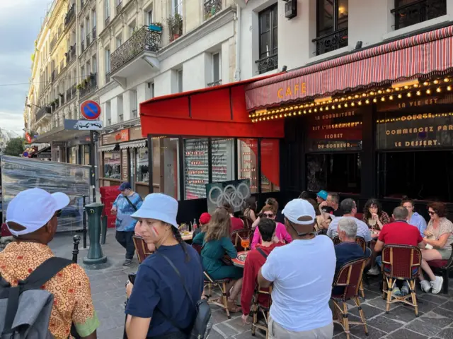 Fans watch basketball in street