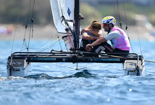 John Gimson and Anna Burnet of Team Great Britain show dejection after their disqualification from the Mixed Multihull