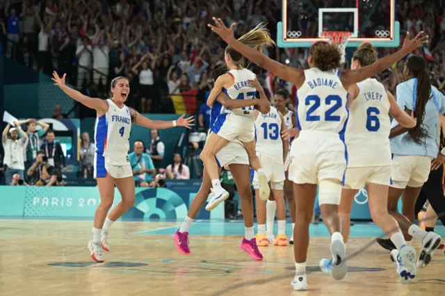 France's #04 Marine Fauthoux and teammates celebrate after winning the women's semifinal basketball match between France and Belgium