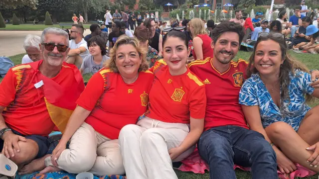 Miguel, Nati, Maria and Miguel pose for a photo in Spanish football shirts, joined by French fan Joy wearing blue