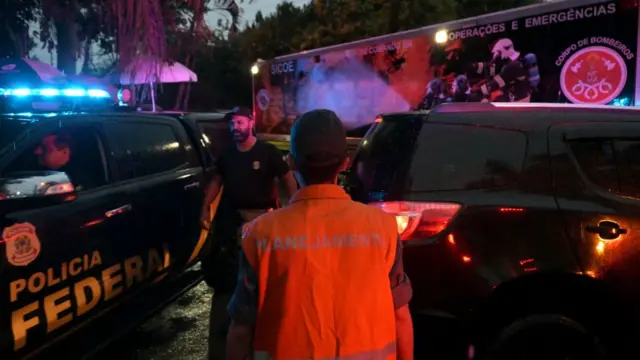 First responders crowd a street near the site of a Brazil plane crash