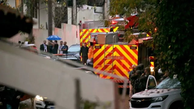 First responder vehicles line a street in Brazil after a plane crashed