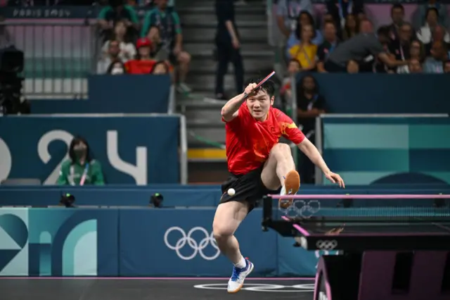 China's Fan Zhendong returns the ball during his men's table tennis singles match