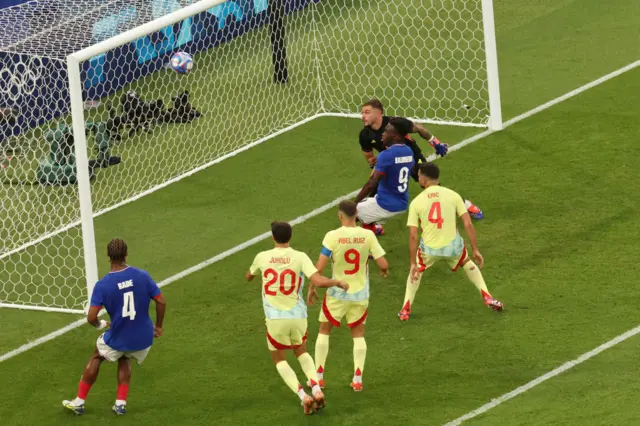 Spain's goalkeeper #01 Arnau Tenas concedes a goal scored by France's midfielder #08 Maghnes Akliouche