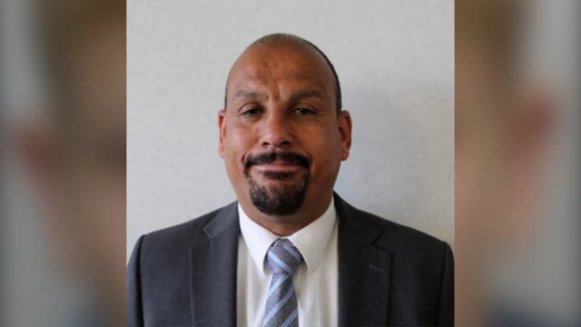 Head shot of Ricky Jones in  a suit with a striped tie