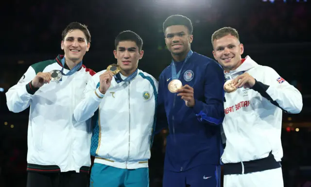 Silver Medalist Marco Alonso Verde Alvarez of Team Mexico (L), Gold Medalist Asadkhuja Muydinkhujaev of Team Uzbekistan (C-L) Bronze Medalist Omari Jones of Team United States (C-R) and Bronze Medalist Lewis Richardson of Team Great Britain (L) pose on the podium