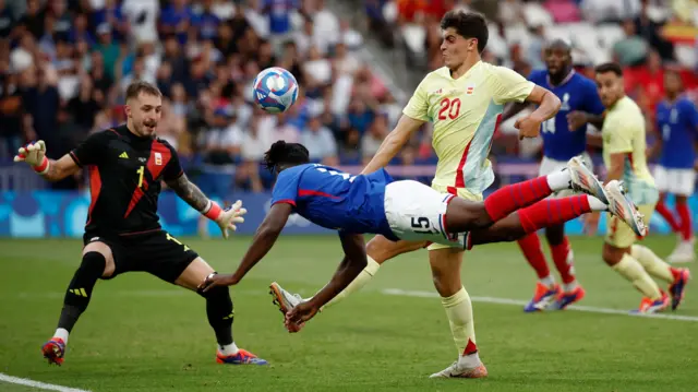 France's Bradley Locko dives for the ball in the men's football final against Spain at the Paris 2024 Olympics