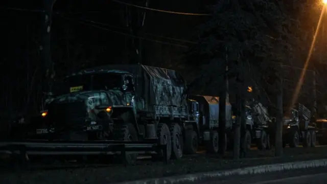 Russian military vehicles advance at night