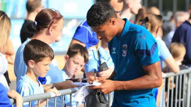 Coventry player signs autographs for fans