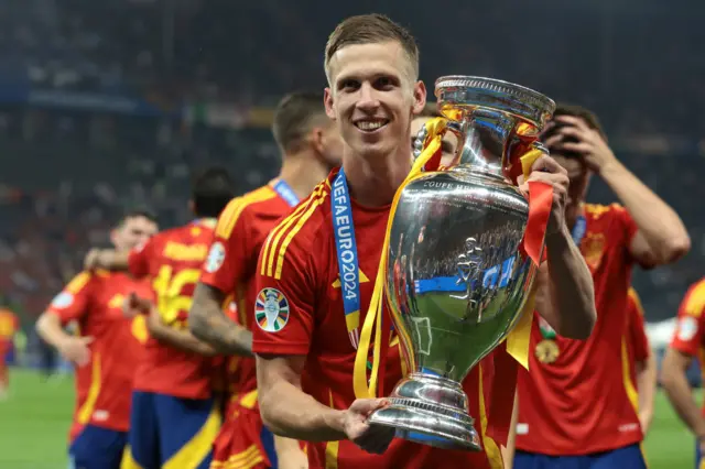 Dani Olmo with the European Championship trophy