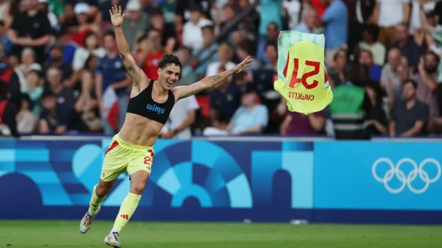 Sergio Camello throws his shirt in the air after scoring for Spain against France in the men's football final at the 2024 Paris Olympics