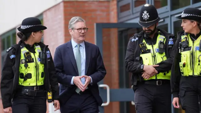 Keir Starmer walks with officers