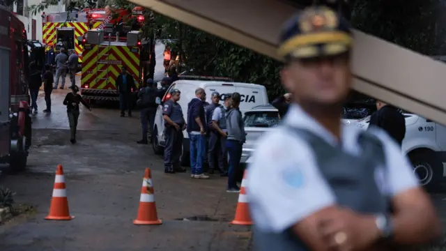 First responders huddle in Brazil after a plane crashed