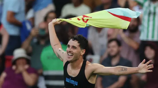 Sergio Camello swings his shirt round his head after scoring for Spain against France in the men's football final at the 2024 Paris Olympics