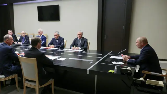 President Putin sits at the head of a table with members of Russia's security council