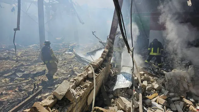 Emergency workers and police comb through the wreckage of a supermarket in Kostyantynivka