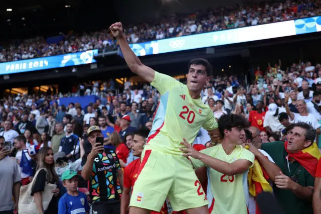 : Juanlu Sanchez #20 of Team Spain celebrates victory with fans