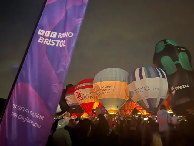 BBC Radio Bristol banner in front of balloon, lit up in the dark