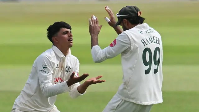 Farhan Ahmed being congratulated by captain Haseeb Hameed