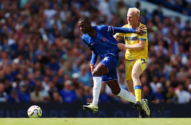 Nicolas Jackson of Chelsea is challenged by Will Hughes