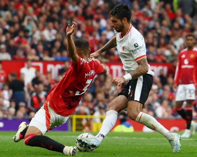 Manchester United's Noussair Mazraoui in action with Liverpool's Dominik Szoboszlai