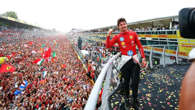 Charles Leclerc celebrates on the podium