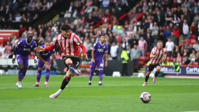 Kieffer Moore takes a penalty