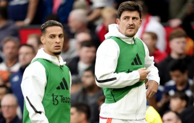 Manchester United's substitutes Harry Maguire (right) and Antony