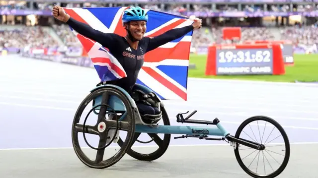 Kare Adenegan holds a Great Britain flag