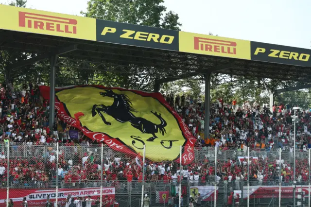 Ferrari fans hold a big flag