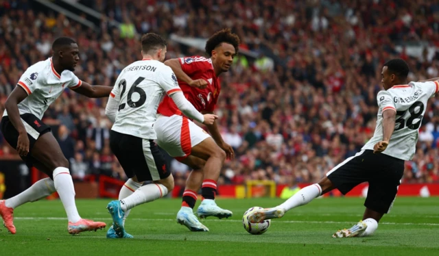 Joshua Zirkzee in action with Liverpool's Ryan Gravenberch and Andrew