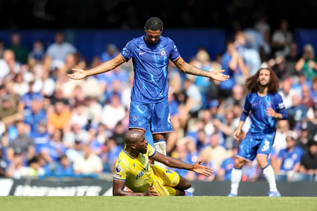 Levi Colwill of Chelsea stand sover Mateta