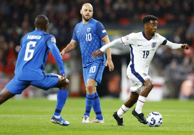 Angel Gomes in action with Finland's Glen Kamara