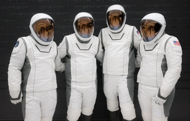 Four astronauts in Space X spacesuits ready for launch