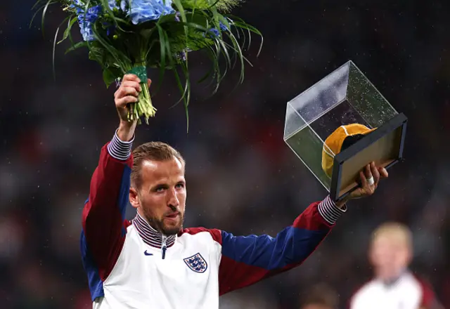 Harry Kane of England holds a Golden Cap given to him to commemorate his 100 England appearances