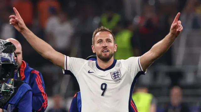 Harry Kane with his arms aloft while representing England