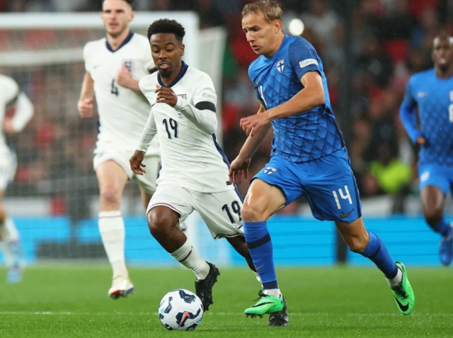 Finland's Topi Keskinen in action with England's Angel Gomes