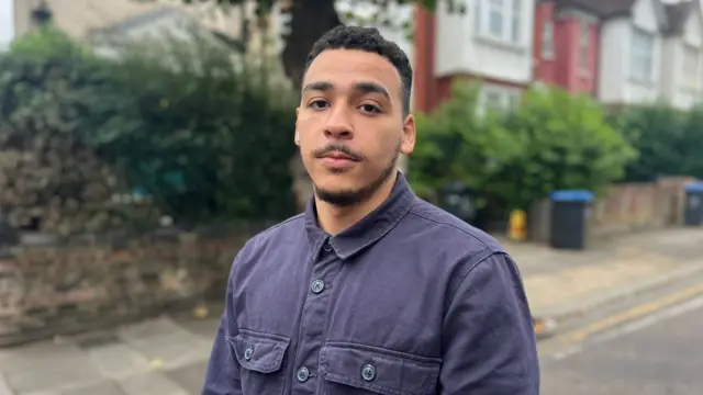 Ex-prisoner Jason standing in a street facing the camera.