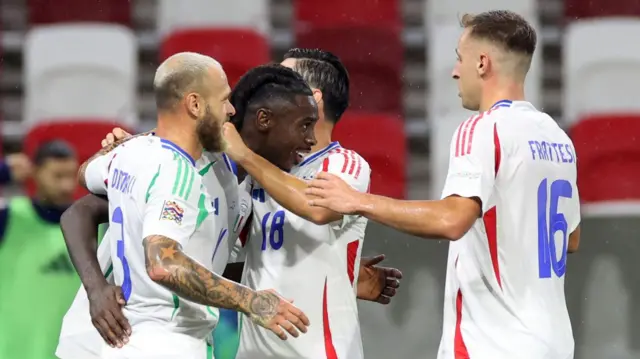 Italy players congratulate Moise Kean after he scores against Israel