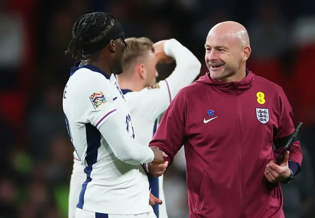 Noni Madueke of England and Lee Carsley, Interim Manager of England, react