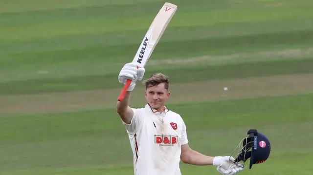 Michael Pepper raises his bat after scoring 100