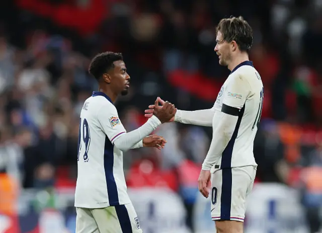 Angel Gomes and Jack Grealish of England interact