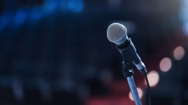 Close up of microphone in concert hall or conference room