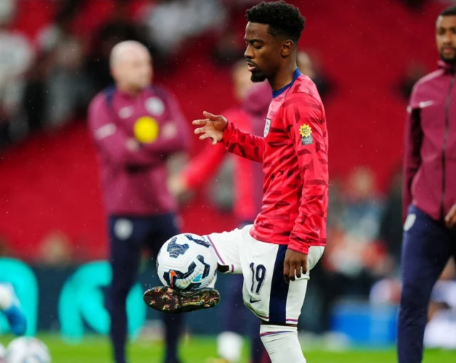 Angel Gomes warms up