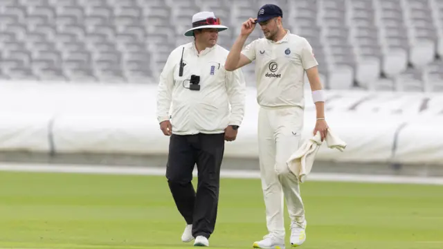 The umpires take the players off for bad light and rain during Middlesex CCC vs Gloucestershire CCC