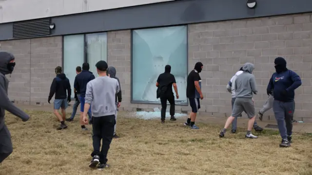 People near a smashed window