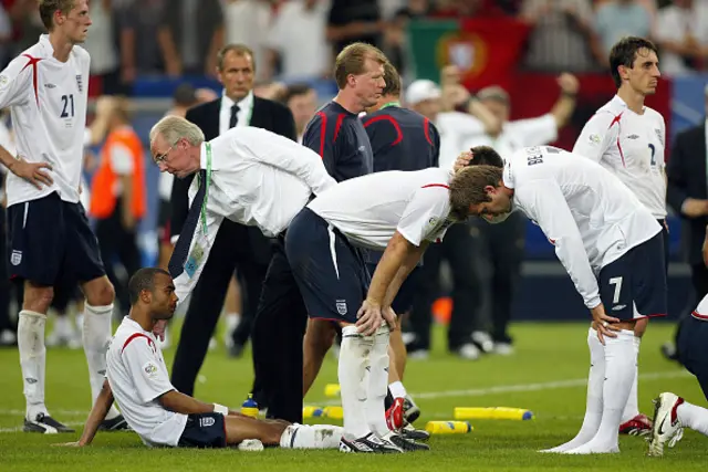 Sven Goran Eriksson consoles Ashley Cole of England while David Beckham consoles John Terry